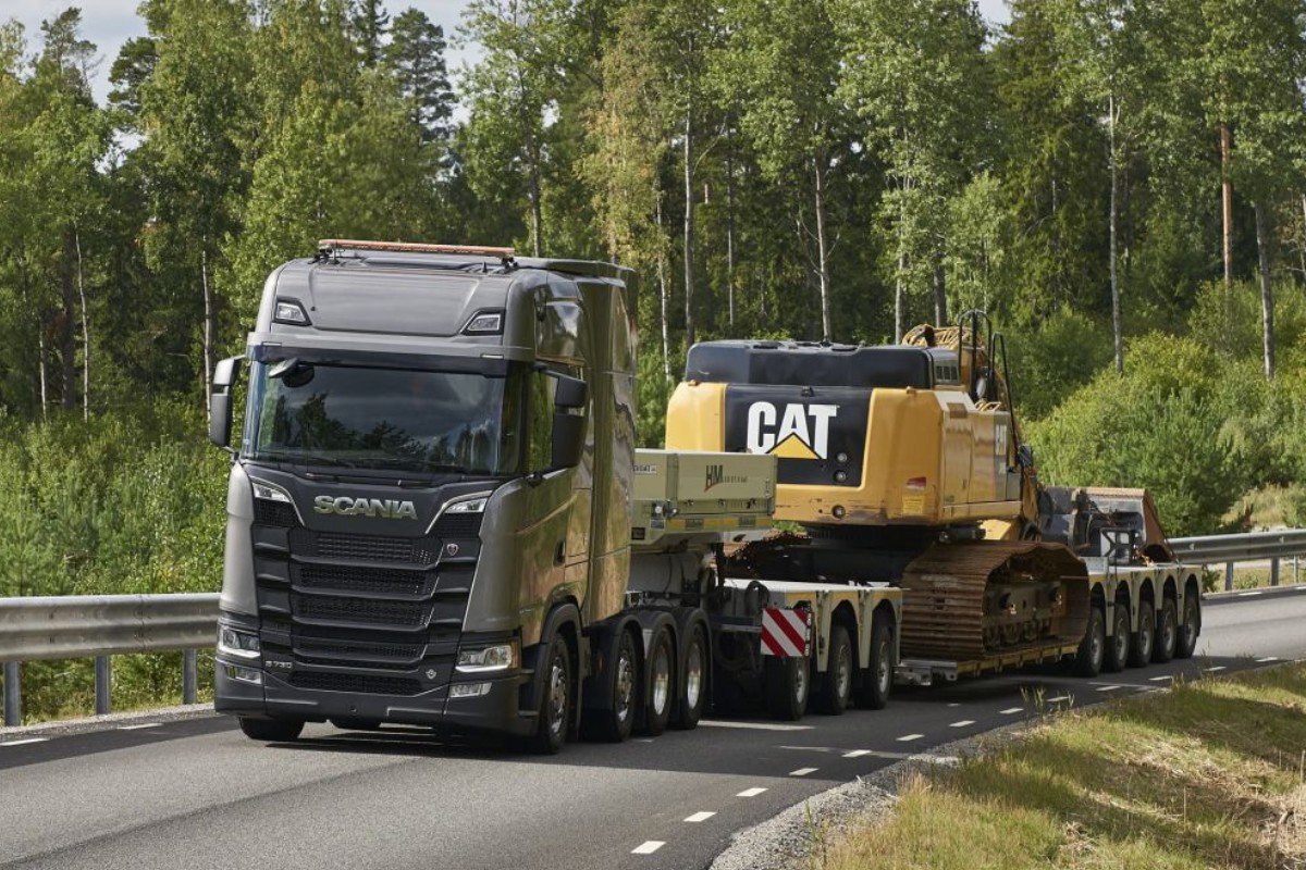 Heavy vehicles secured on a multi-level vehicle transport truck